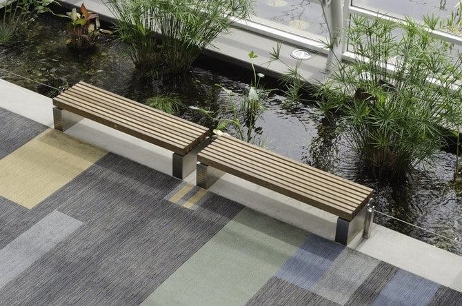 Pair of benches alongside long artificial pond inside convention center
